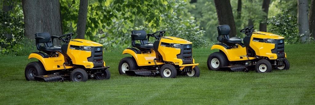 yellow lawn tractors on cut grass Small Engine Repair, Certified Cub Cadet Dealer