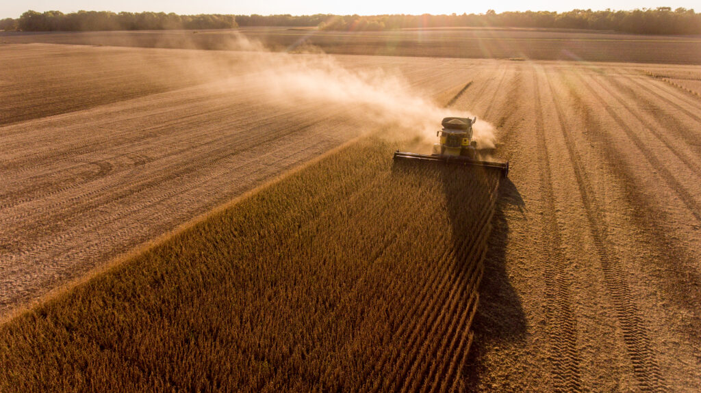 Photo from above of a combine harvesting in a wheat field